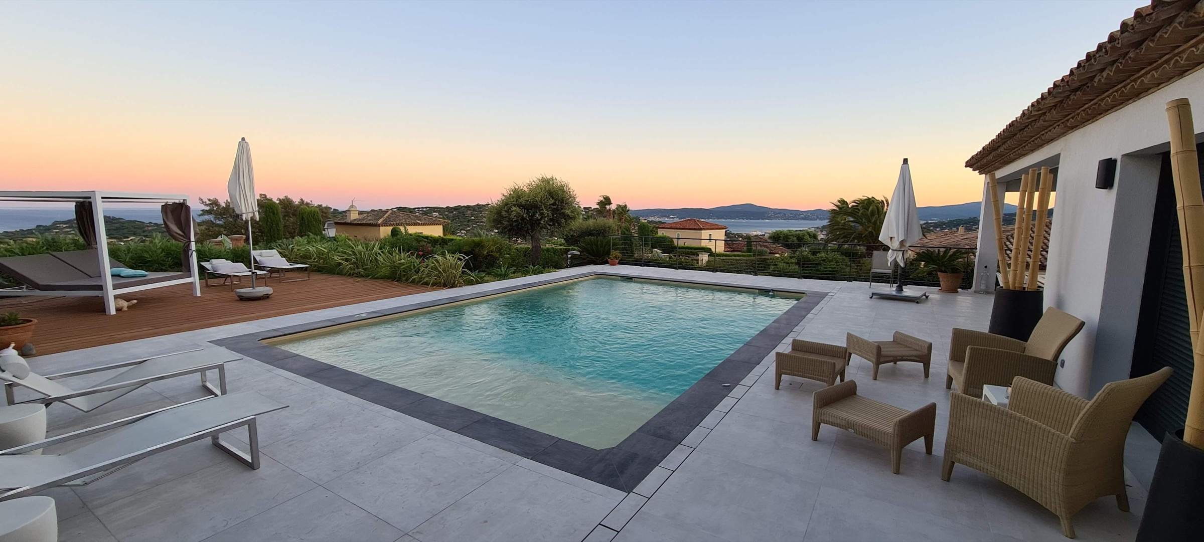 Pool and terrace at dusk over the gulf